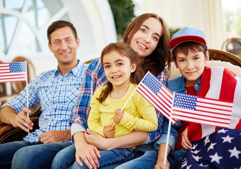 Family of patriots with USA flags on Independence Day