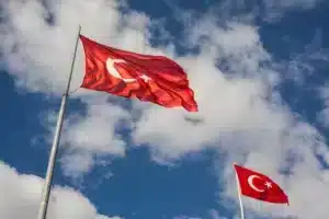 Turkish flag in a blue sky with white clouds 