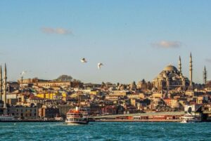 Boat floating on the blue waters of the Turkish coast with Istanbul in the background